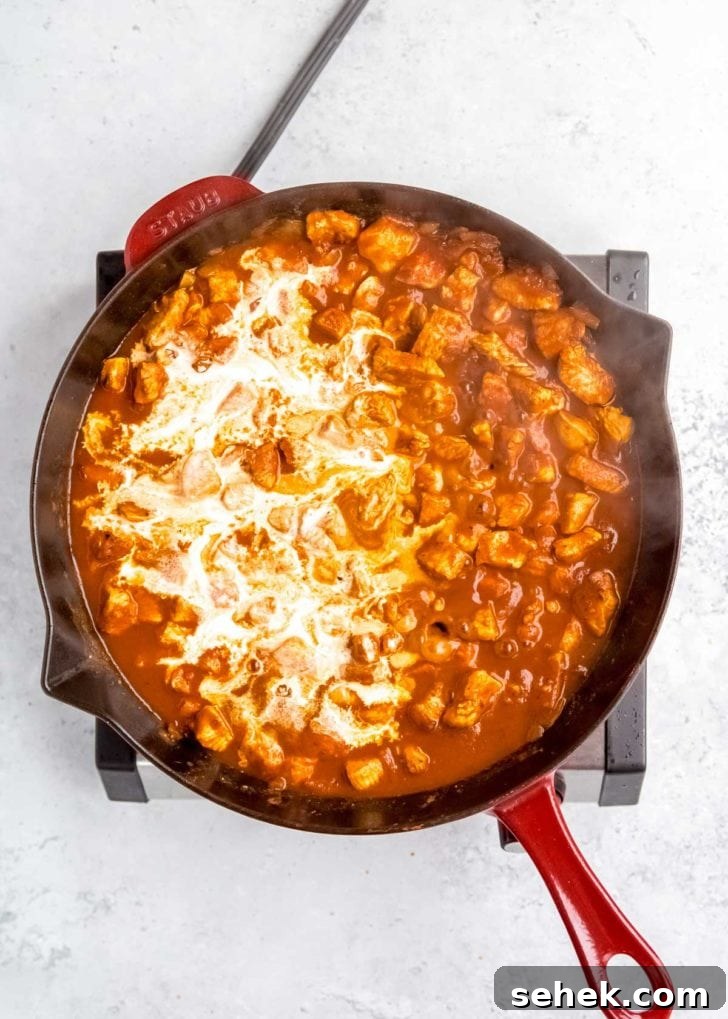 Creamy Indian Butter Chicken Recipe 11 yogurt being added to butter chicken