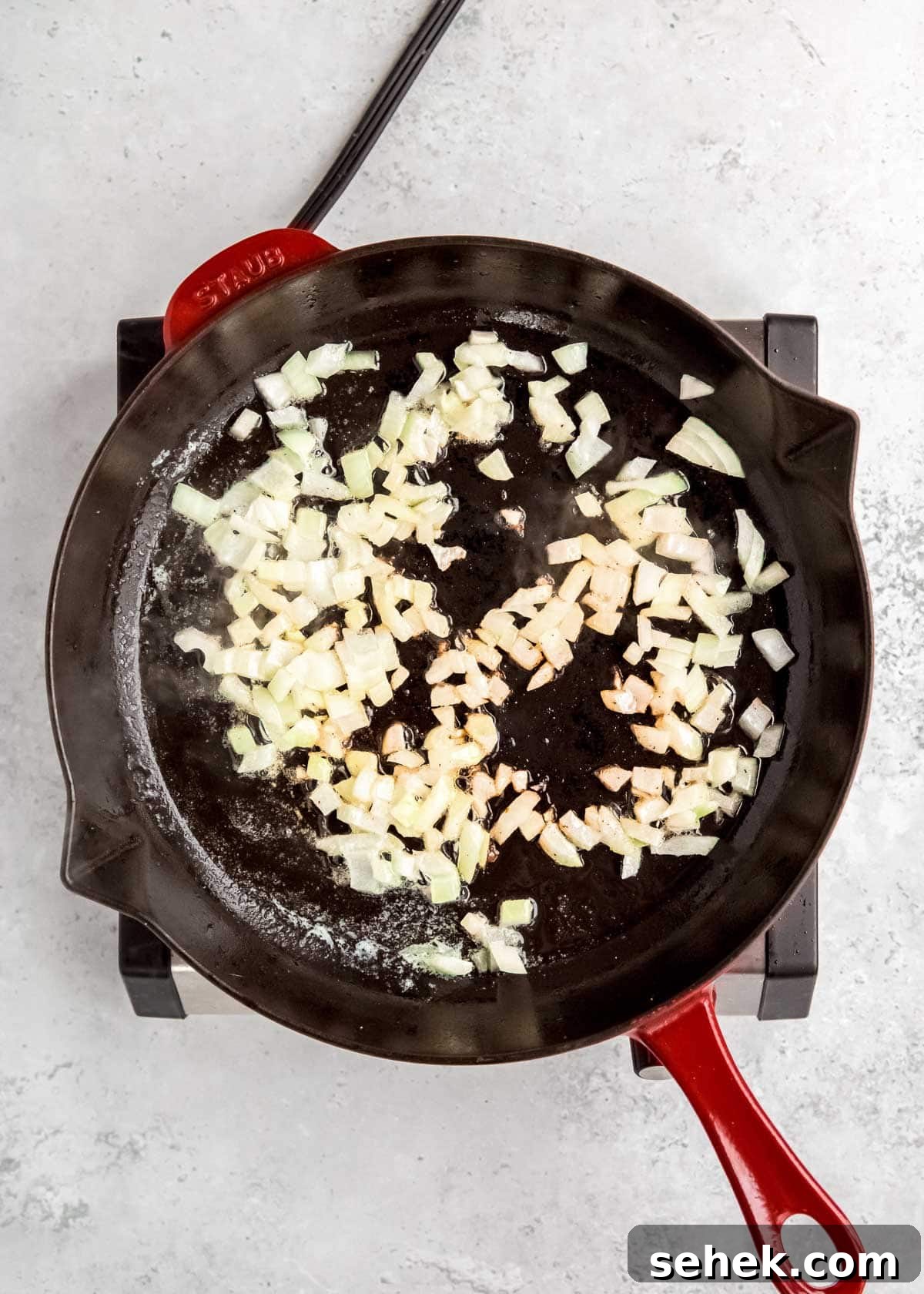 Creamy Indian Butter Chicken Recipe 5 overhead image of onions being sauteed in skillet