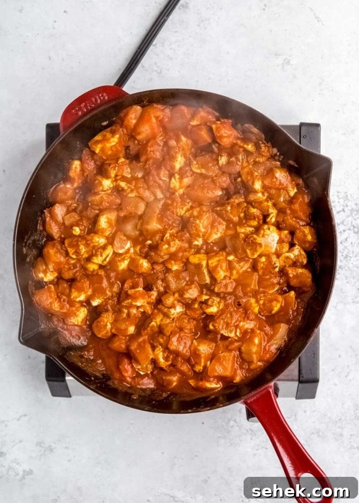 Creamy Indian Butter Chicken Recipe 9 overhead image of butter chicken being cooked in skillet