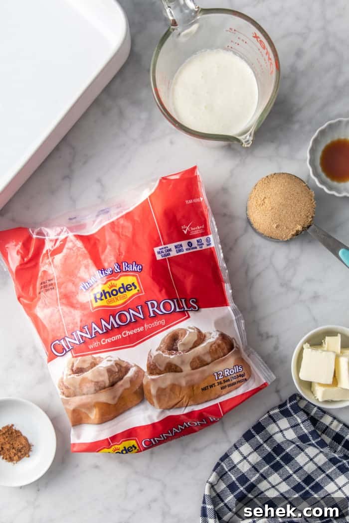 TikTok Cinnamon Rolls Made with Heavy Cream 4 Ingredients for tiktok cinnamon rolls, aka cinnamon rolls with heavy cream, arranged on a marble countertop.