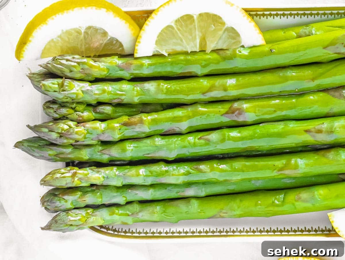 How to Cook Asparagus: Roasting, Sautéing and Steaming Tips 5 Steamed asparagus with lemon slices.