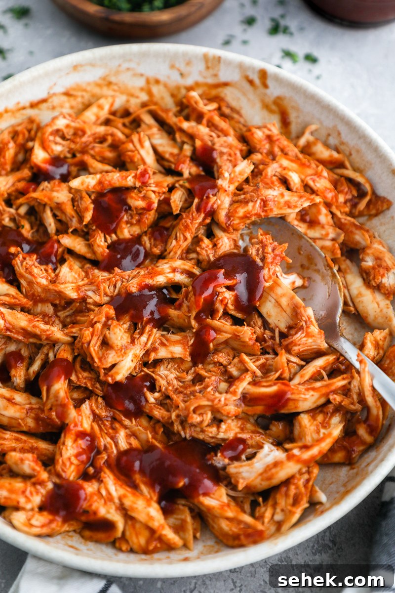 Crispy BBQ Chicken Tortilla Pizzas 4 A bowl of shredded chicken mixed with bbq sauce
