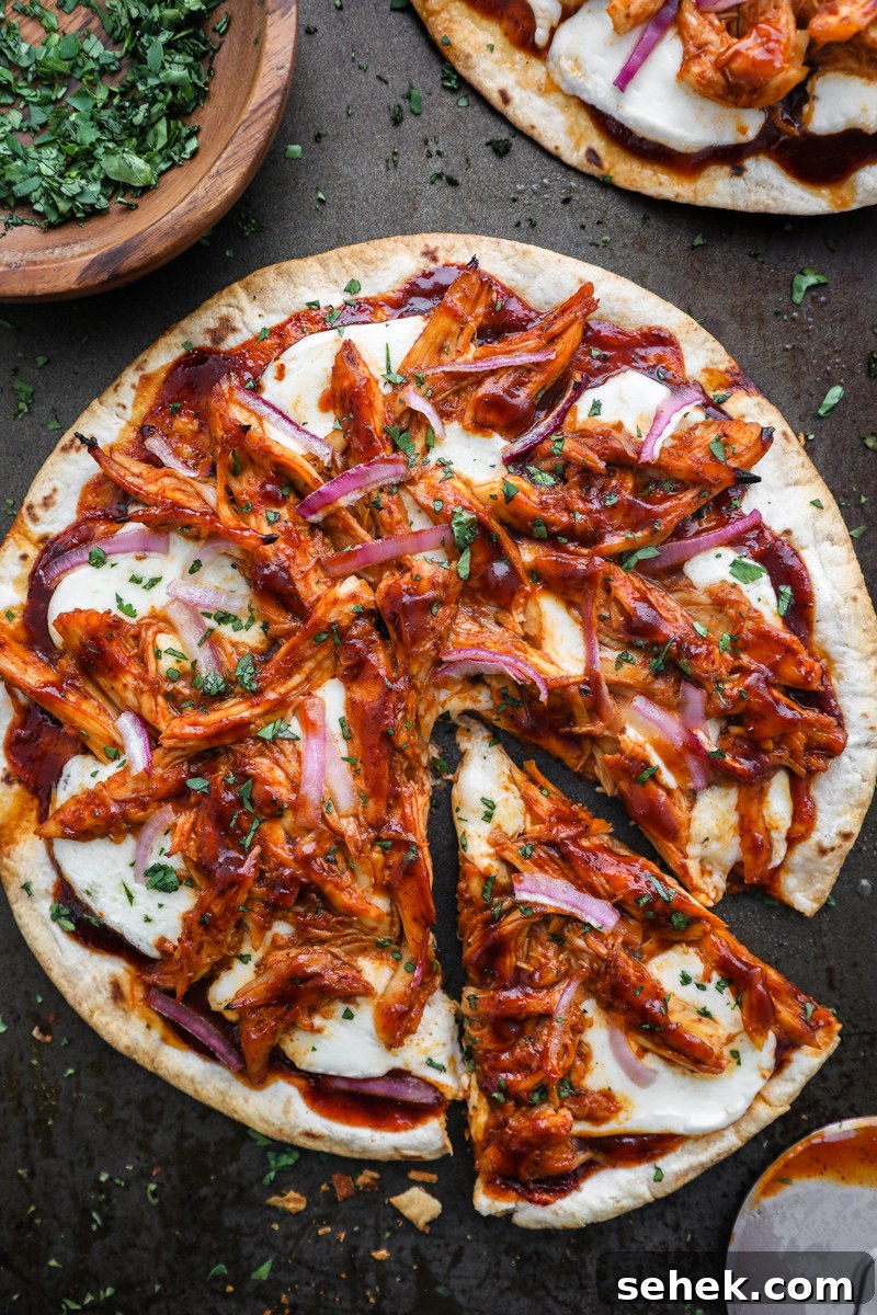 Crispy BBQ Chicken Tortilla Pizzas 7 A bbq chicken tortilla pizza sprinkled with cilantro with one slice removed