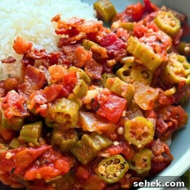 Classic Southern Potato Salad Recipe 12 A close-up of a plate featuring stewed okra and tomatoes alongside a serving of fluffy white rice.