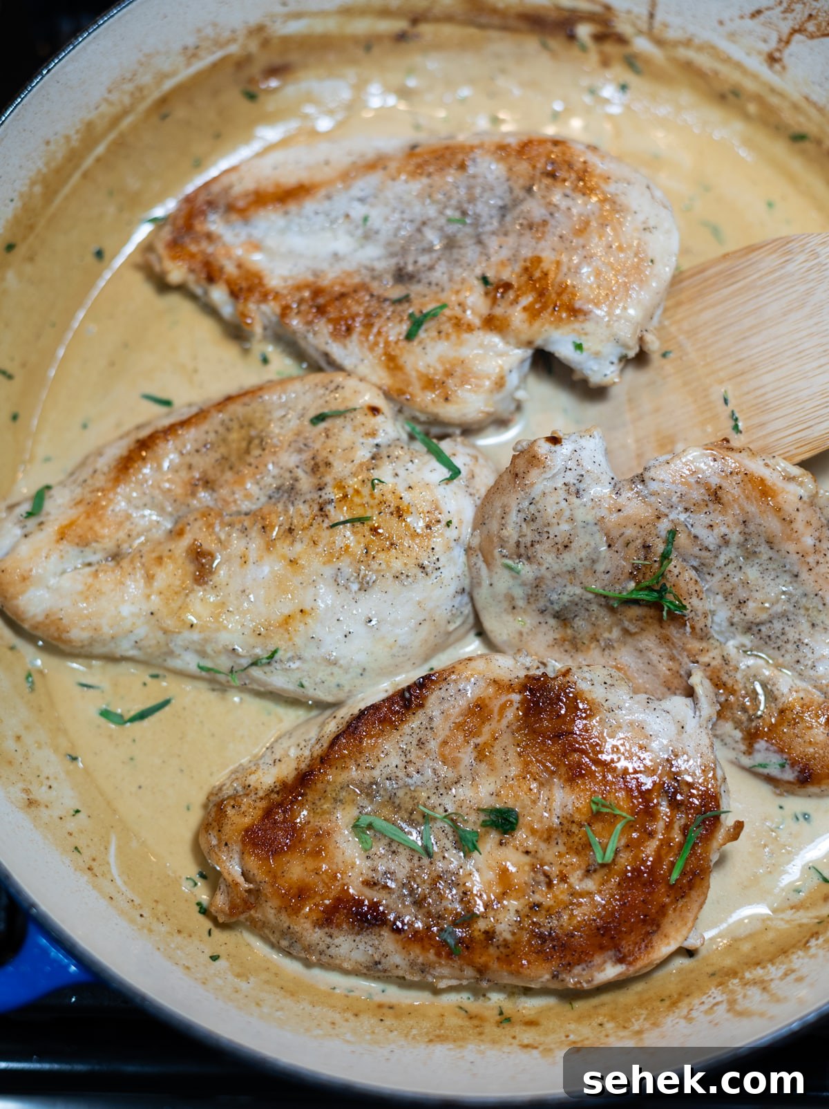 Skillet Chicken with Creamy Mustard Sauce 11 Chicken breasts being cooked in a skillet.