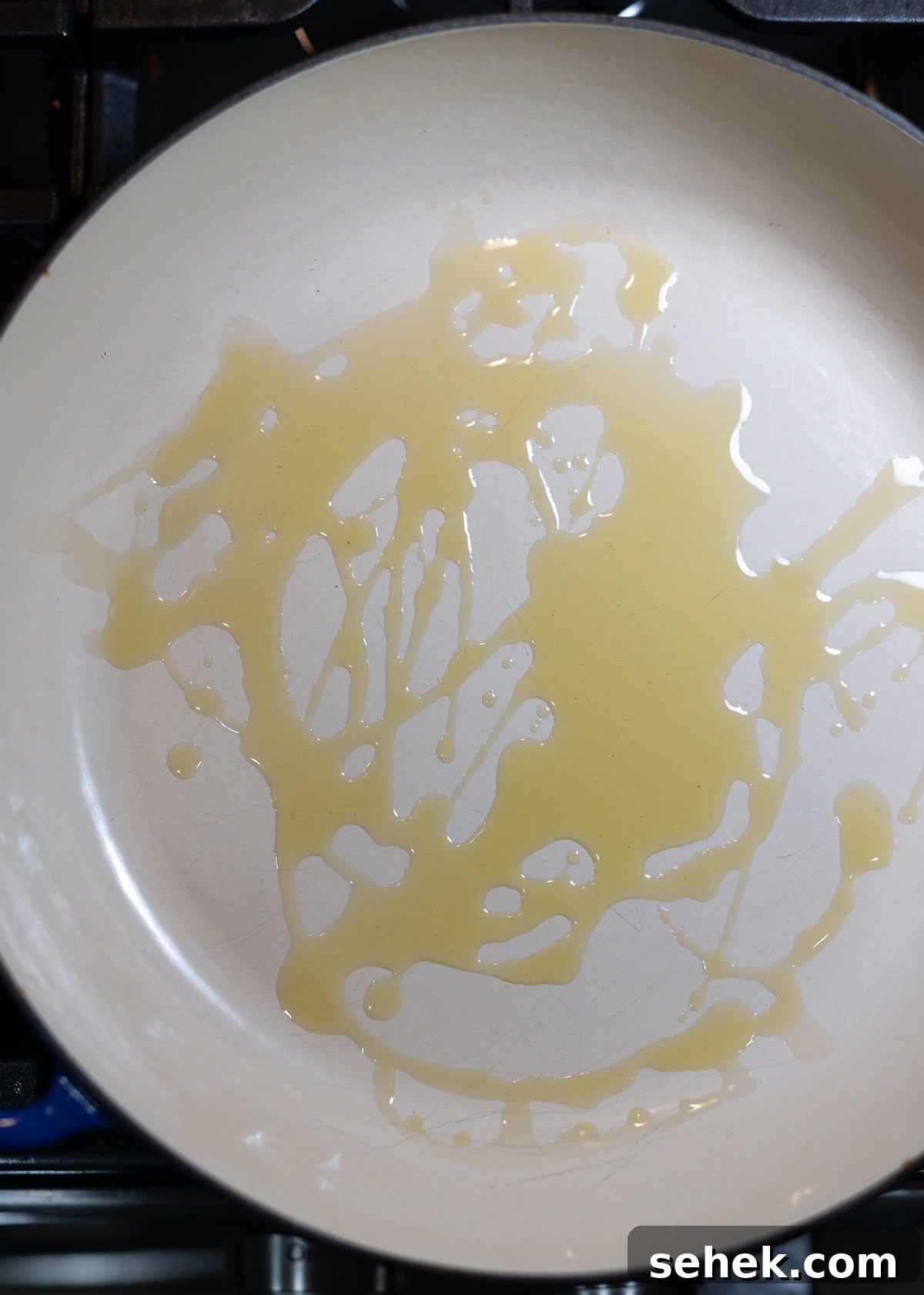 Skillet Chicken with Creamy Mustard Sauce 5 Olive oil being heated in a skillet.