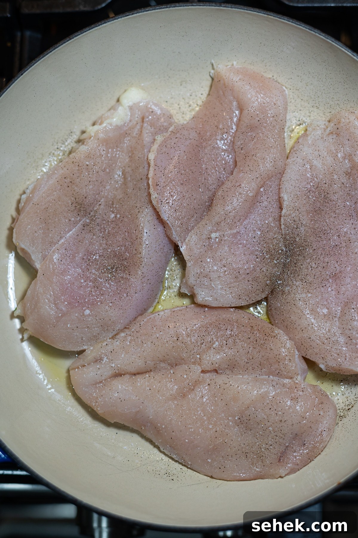 Skillet Chicken with Creamy Mustard Sauce 6 4 chicken breasts being sautted in a skillet.