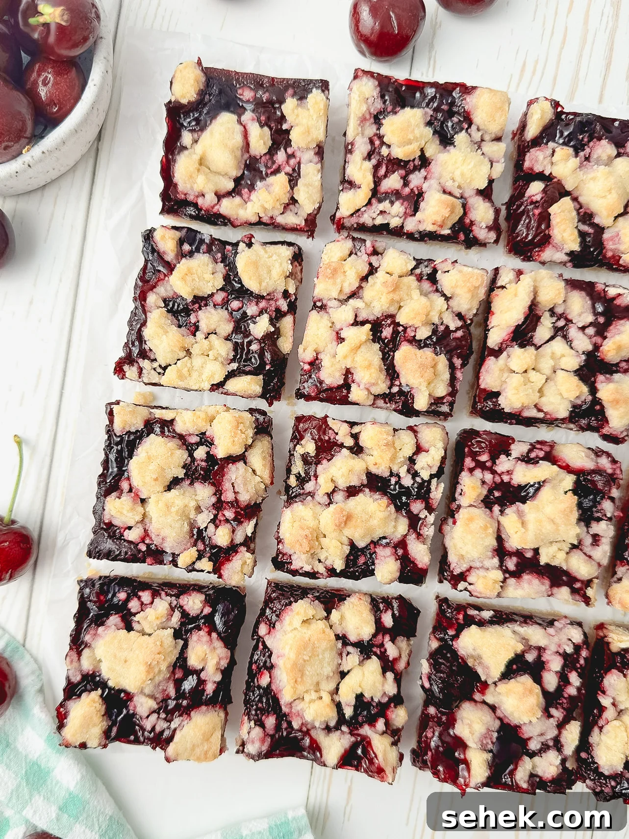 Cherry Crumb Bars with Buttery Streusel 6 Sliced cherry crumb bars on a plate